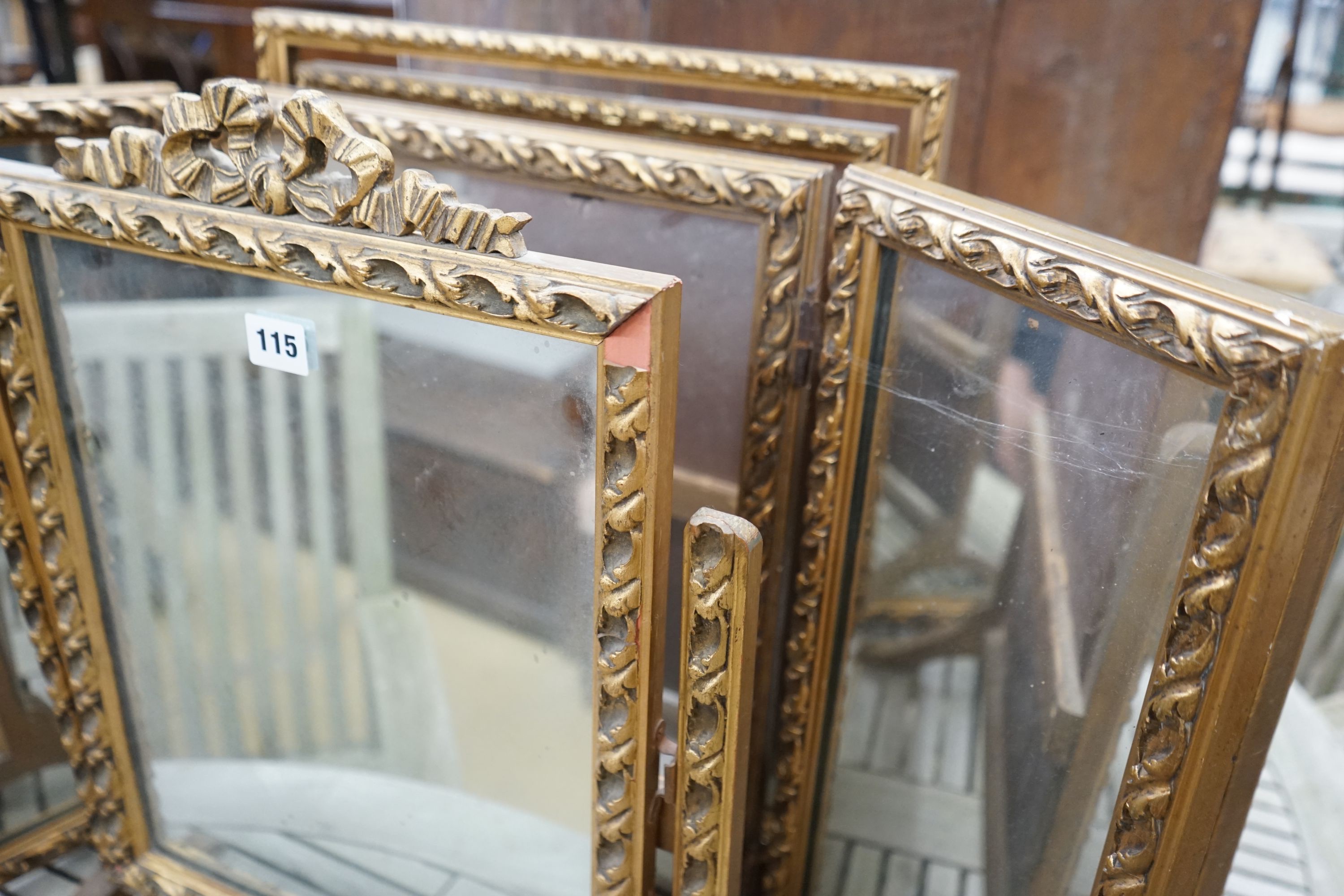 Two gilt framed triple dressing table mirrors together with a similar toilet mirror, largest height 52cm